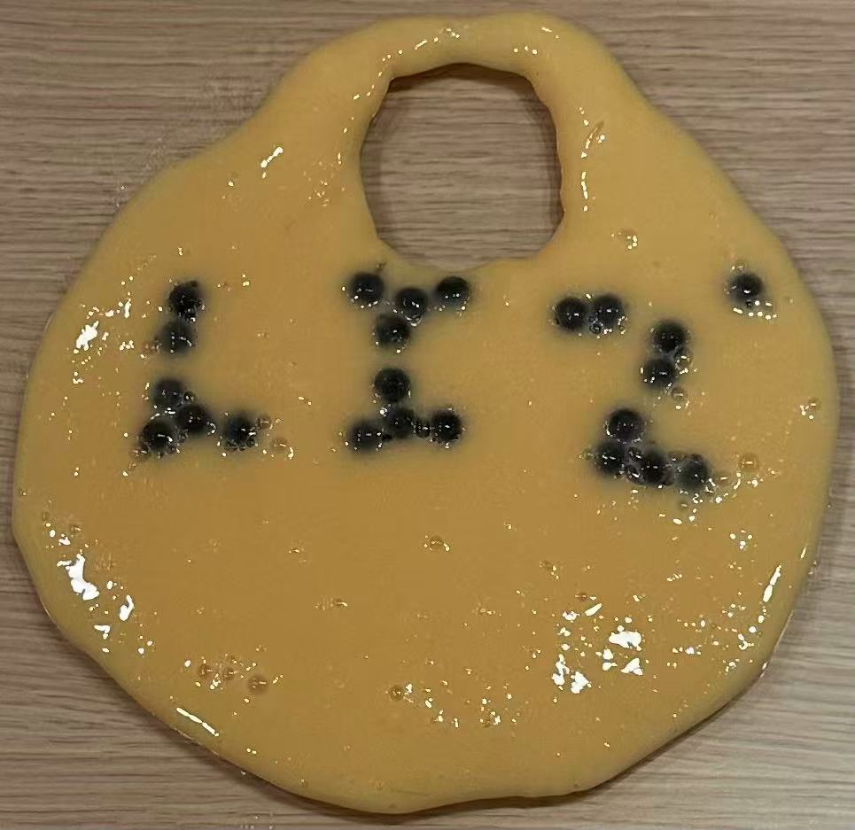 LIZ' spelled in boba pearls on fresh dough